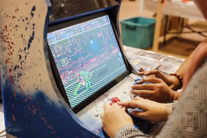 Visitors at the Infinity Convention trying out retro video games. April 26, 2019. Photo: Hazimul Wa'ie/The Scoop